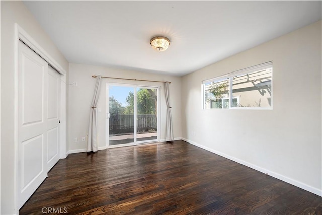 unfurnished room featuring dark hardwood / wood-style floors