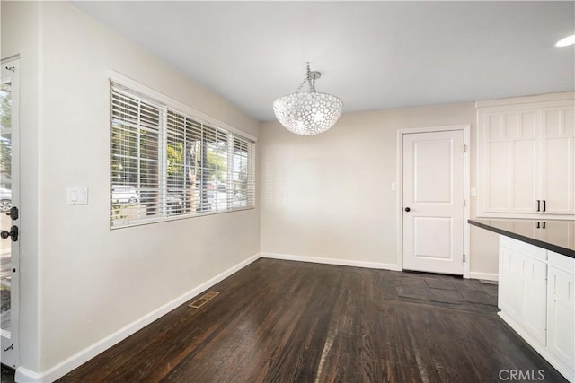 unfurnished dining area with dark hardwood / wood-style floors