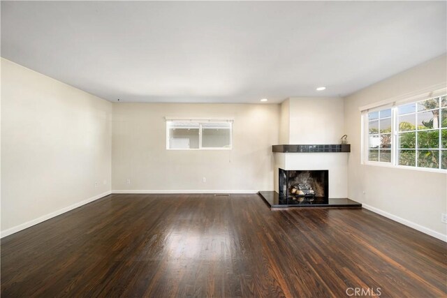 unfurnished living room featuring dark hardwood / wood-style floors