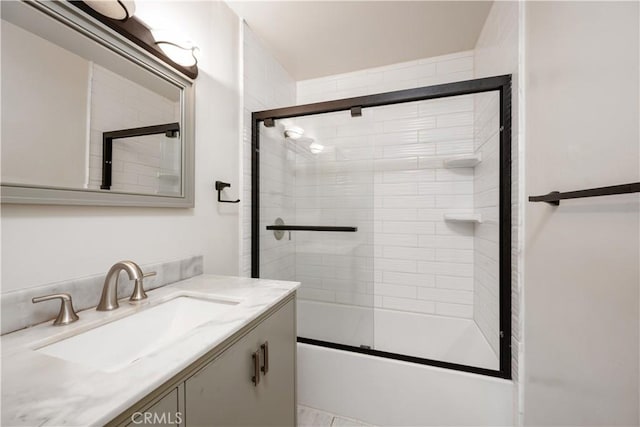 bathroom featuring vanity and combined bath / shower with glass door