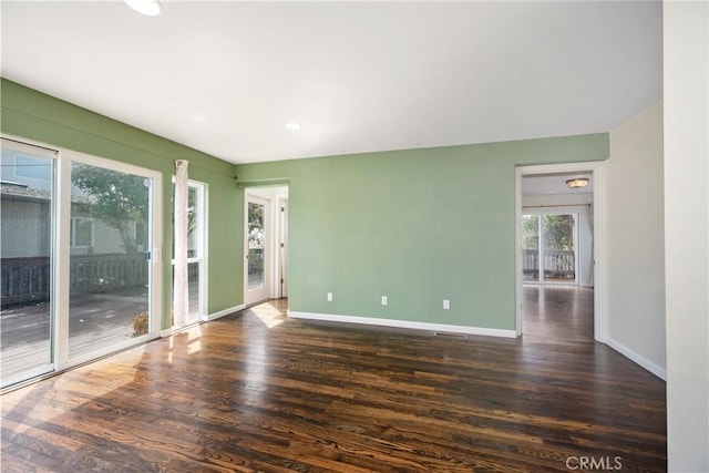 unfurnished room featuring dark hardwood / wood-style flooring