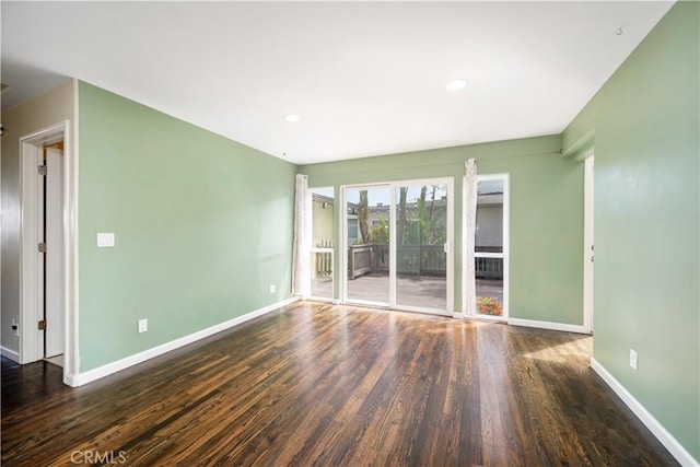 unfurnished room with dark hardwood / wood-style floors