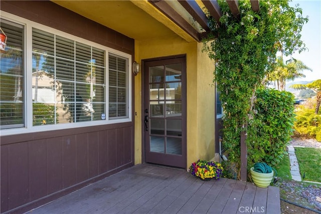 doorway to property featuring a wooden deck