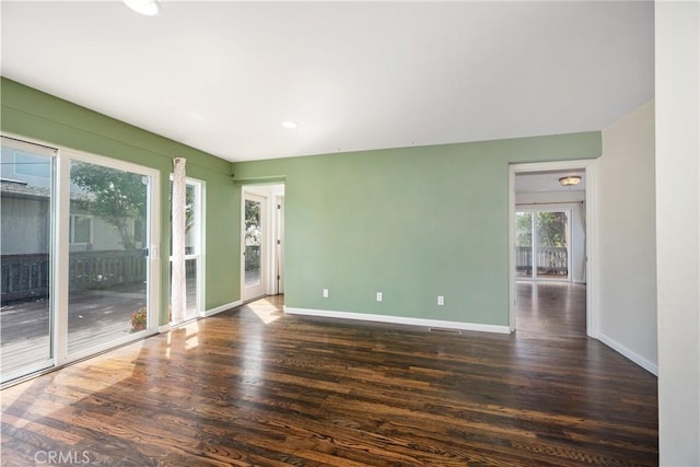 empty room featuring dark wood-type flooring