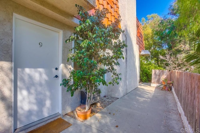 view of exterior entry featuring a patio