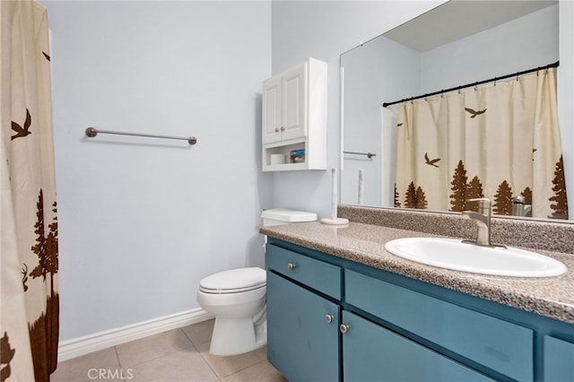 bathroom with vanity, tile patterned flooring, and toilet