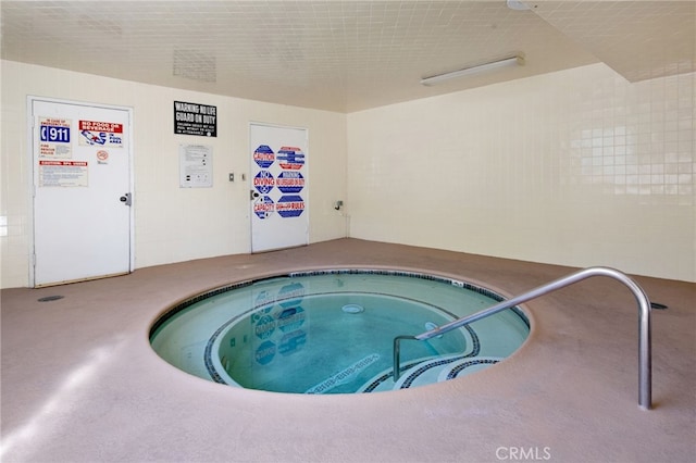 view of swimming pool featuring an indoor in ground hot tub