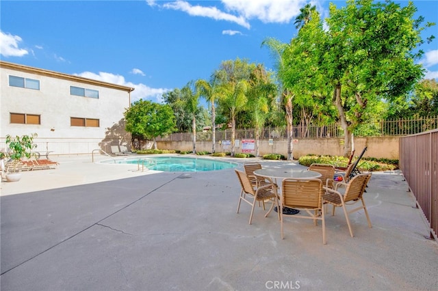 view of swimming pool with a patio