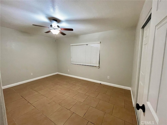 unfurnished bedroom with tile patterned flooring, ceiling fan, and a textured ceiling