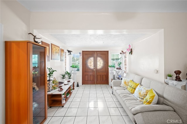 foyer entrance featuring a textured ceiling and light tile patterned flooring