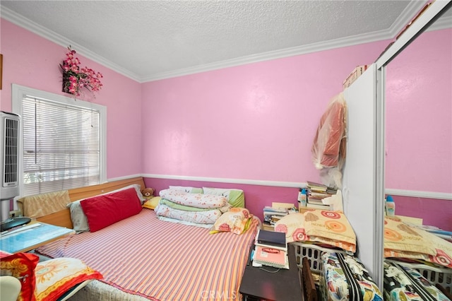 bedroom with ornamental molding and a textured ceiling