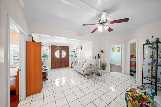 tiled living room featuring ceiling fan