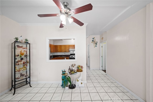 kitchen with ceiling fan, range with electric stovetop, light tile patterned flooring, and crown molding