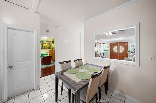 dining room featuring ceiling fan, crown molding, and light tile patterned floors