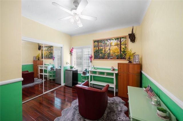 home office featuring ceiling fan, a baseboard radiator, and dark hardwood / wood-style floors