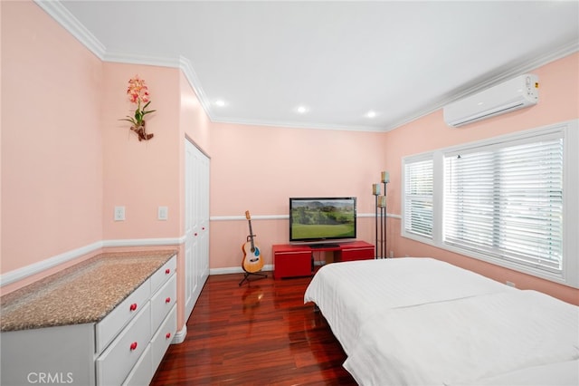 bedroom with ornamental molding, a wall unit AC, and dark wood-type flooring