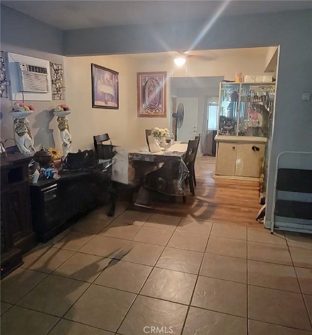 dining space with hardwood / wood-style floors and a wall mounted air conditioner