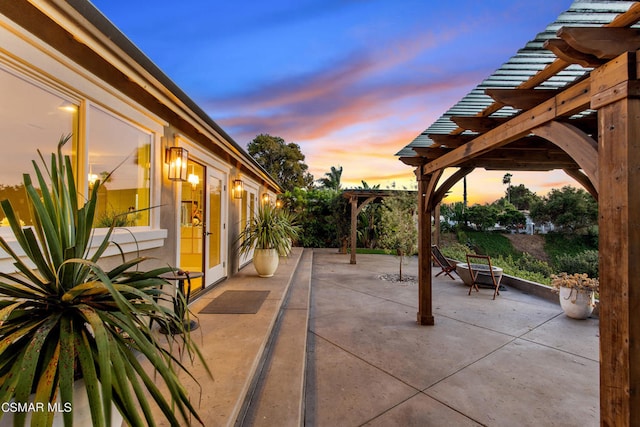 patio terrace at dusk with a pergola