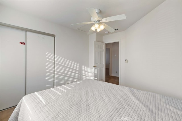 bedroom with a closet, ceiling fan, and wood-type flooring