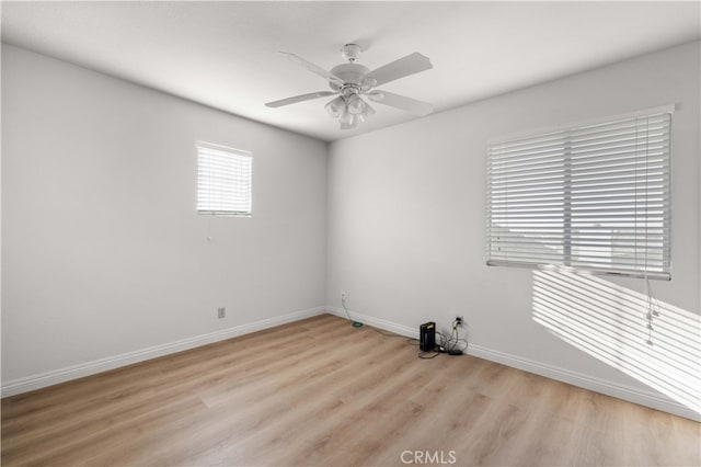 spare room featuring ceiling fan and light hardwood / wood-style flooring