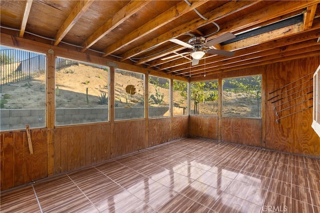 unfurnished sunroom with ceiling fan and plenty of natural light