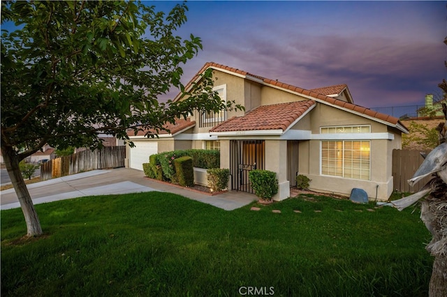 view of front of property with a yard and a garage