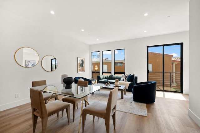 dining space featuring light wood-type flooring and plenty of natural light