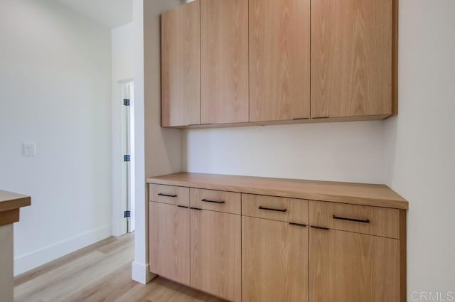 kitchen featuring light wood-type flooring and light brown cabinetry