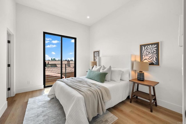 bedroom featuring light wood-type flooring and access to outside