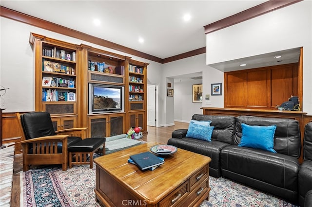 living room featuring light hardwood / wood-style floors and crown molding