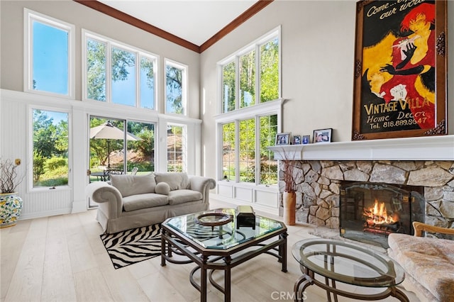 sunroom / solarium featuring a stone fireplace