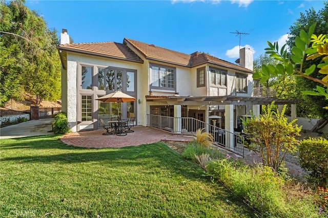 back of house featuring a yard, a pergola, and a patio area