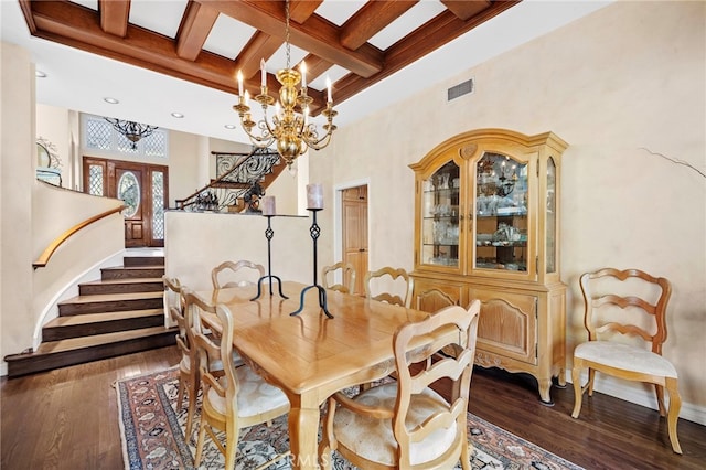 dining room with coffered ceiling, beam ceiling, french doors, dark hardwood / wood-style floors, and a chandelier