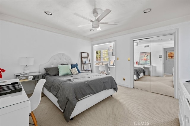 carpeted bedroom featuring ceiling fan and a closet