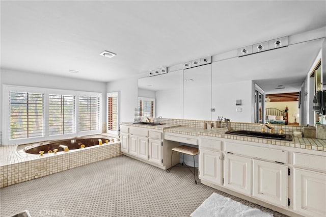 bathroom with a tub to relax in and vanity