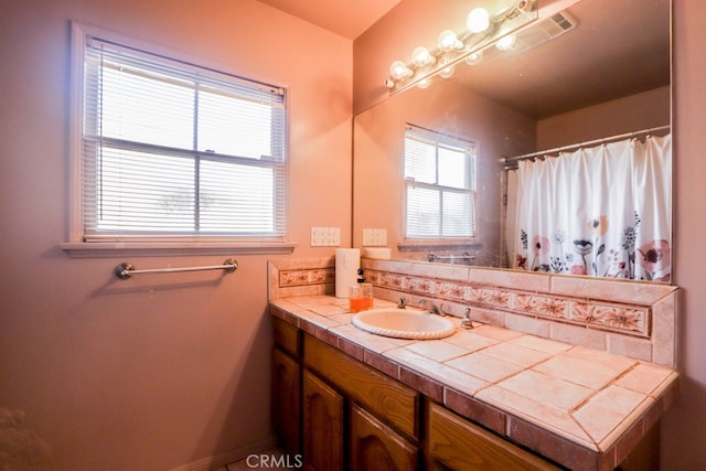 bathroom featuring a shower with curtain and vanity