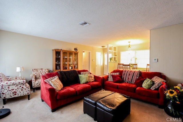 living room with a textured ceiling and carpet flooring