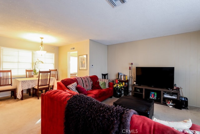 carpeted living room featuring a textured ceiling