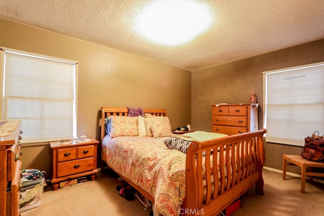 bedroom with light carpet and a textured ceiling