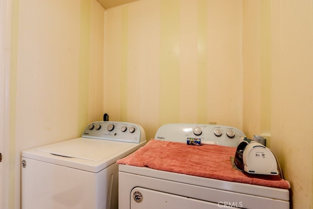 clothes washing area featuring washer and clothes dryer