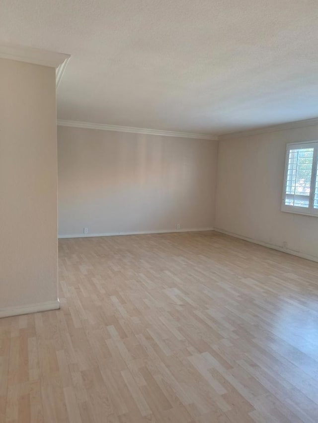 unfurnished room with light hardwood / wood-style flooring, ornamental molding, and a textured ceiling