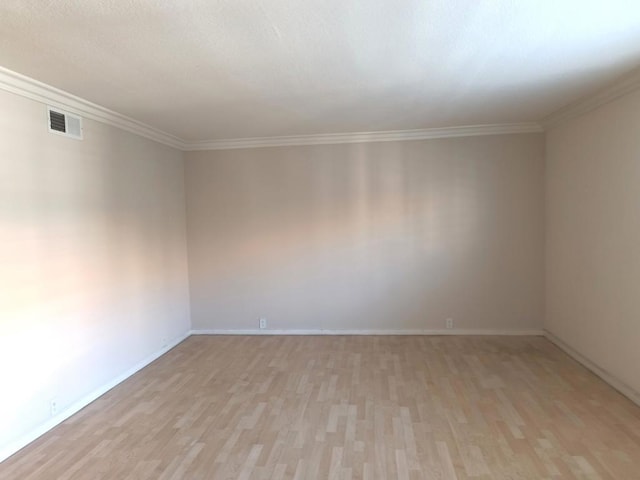 unfurnished room with ornamental molding and light hardwood / wood-style floors