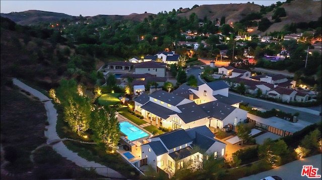 birds eye view of property with a mountain view