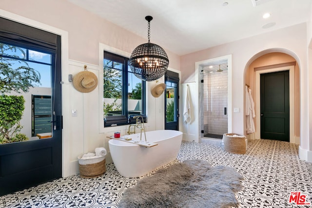 bathroom with a wealth of natural light, tile patterned floors, and independent shower and bath