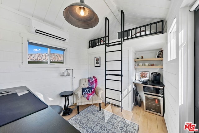 office space featuring vaulted ceiling, light wood-type flooring, wooden walls, and a wall unit AC