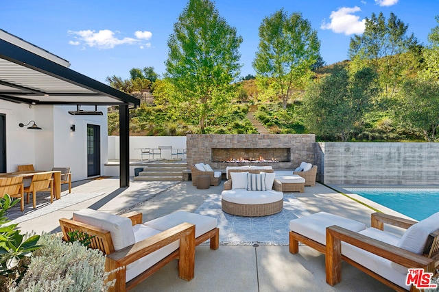 view of patio / terrace with a fenced in pool and an outdoor hangout area