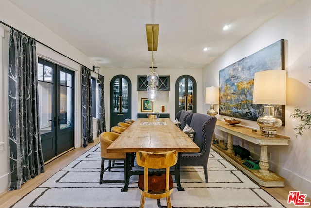 dining room with french doors and light wood-type flooring