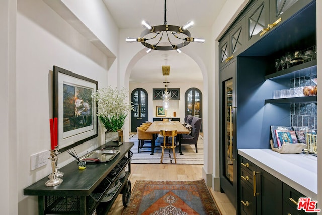 interior space featuring an inviting chandelier and light hardwood / wood-style floors