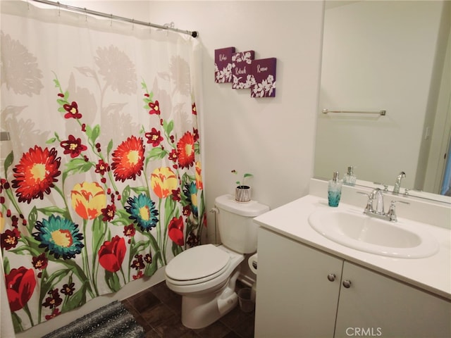 bathroom with tile patterned flooring, curtained shower, vanity, and toilet