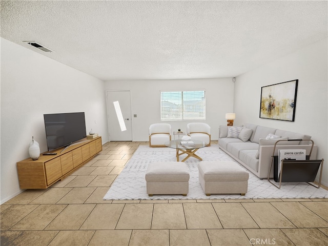 tiled living room with a textured ceiling